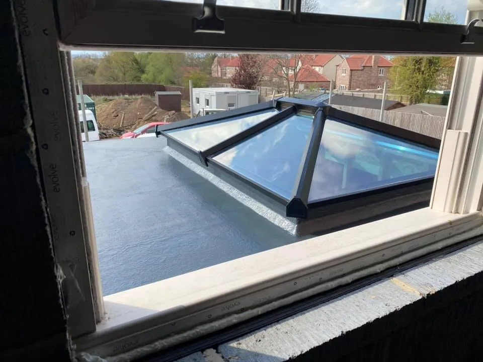 GRP fibreglass flat roof with a glazed roof lantern installed